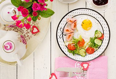 Sevgililer Günü ' - bir kalp, tost, sosis ve taze sebze şeklinde kızarmış yumurta kahvaltı. Bir fincan kahve. İngiliz kahvaltısı. Üstten Görünüm