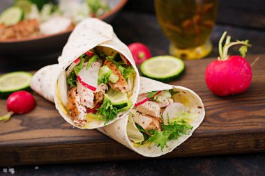 Fırında tavuk göğsü, salatalık, turp ve marul ile sağlıklı Meksika tacos.