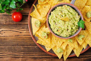 Guacamole avokado, limon, domates, soğan ve Salantro, cips ile - geleneksel Meksika aperatif servis. Düz yatıyordu. Üstten Görünüm.