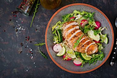 Salata taze sebze ve karanlık bir arka plan üzerinde pişmiş tavuk göğsü ile top. Doğru beslenme. Diyet menüsü. Düz yatıyordu. Üstten Görünüm