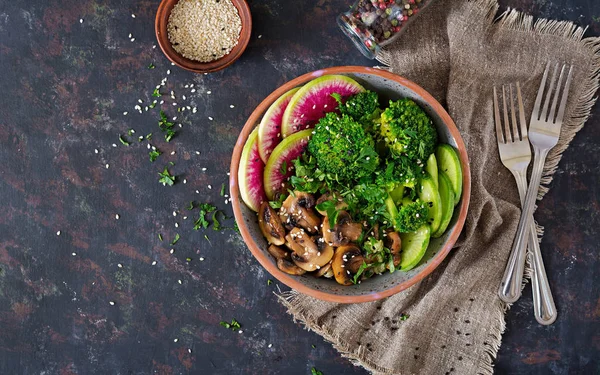 Vegan buddha bowl dinner food table. Healthy food. Healthy vegan lunch bowl. Grilled mushrooms, broccoli, radish salad. Flat lay. Top view.