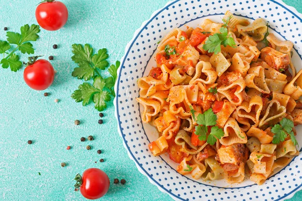 pasta in shape of hearts with chicken and tomatoes in tomato sauce