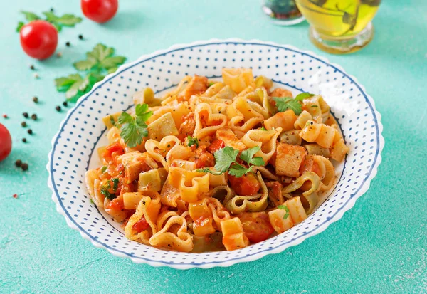 pasta in shape of hearts with chicken and tomatoes in tomato sauce