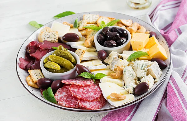 Antipasto platter with basturma, salami, blue cheese, nuts, pick