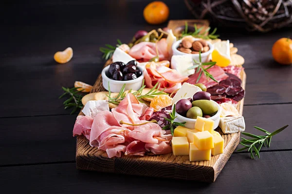 Antipasto Platter Ham Prosciutto Salami Cheese Crackers Olives Wooden Background — 스톡 사진