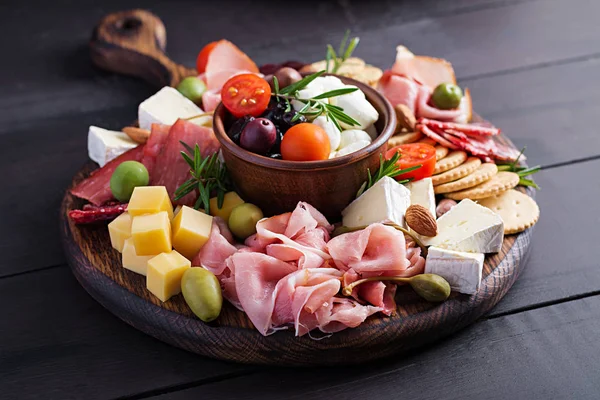 Antipasto Platter Ham Prosciutto Salami Cheese Crackers Olives Wooden Background — 스톡 사진