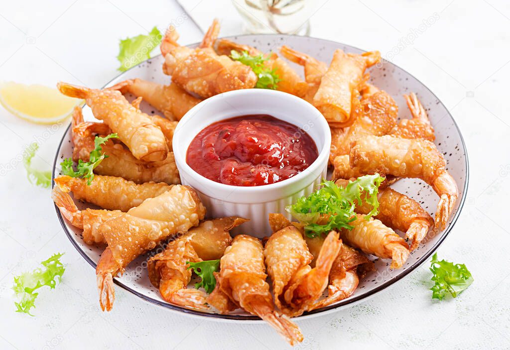 Shrimps with ginger in filo pastry with sweet and sour sauce. Thai cuisine. Deep-fried prawns.