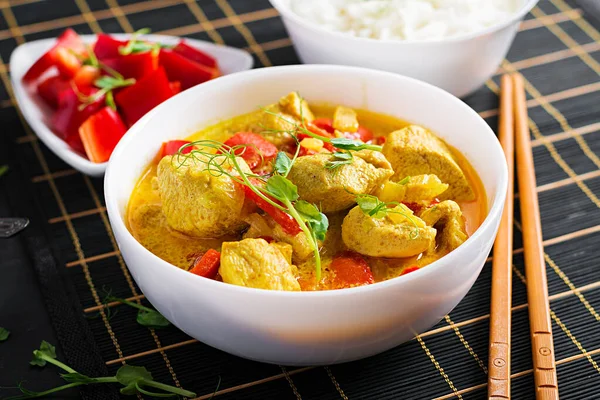 Indian chicken curry with basmati rice in bowl.  Traditional Indian dish. Chicken tikka masala. Indian cuisine.