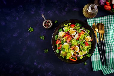 Sebzeli taze salata, domates, kırmızı soğan, marul ve bıldırcın yumurtası. Sağlıklı gıda ve diyet konsepti. Vejetaryen yemeği. Üst görünüm, genel görünüm