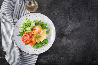 Ketogenik öğle yemeği. Domatesli tavuk burger, salatalık, peynir ve ekmeksiz roka salatası. Tavuk köftesi. Sağlıklı yiyecekler. Keto / paleo diyeti. Üst görünüm, genel görünüm