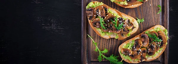 Bruschetta Sandwich Mit Avocado Gebratenen Pilzen Sesam Auf Einem Holzbrett — Stockfoto