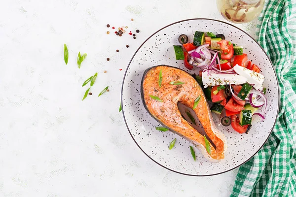 Stock image Ketogenic lunch. Baked salmon garnished with greek salad. Healthy dinner. Keto/paleo diet. Top view, flat lay, copy space