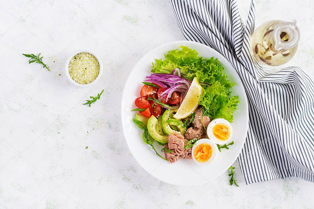 Healthy food. Tuna fish salad with eggs, lettuce, cherry tomatoes, avocado and red onions.  French cuisine. Top view, copy space, flat lay