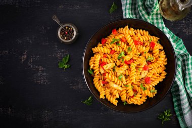 Tavuklu Fusilli makarna ve domates soslu tatlı biber. İtalyan mutfağı. Üst görünüm, düz görünüm, genel görünüm