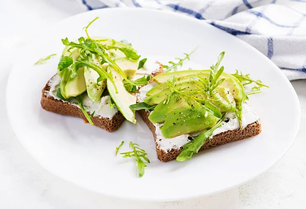 Sándwich Pan Queso Crema Rebanadas Aguacate Plato Sobre Fondo Claro —  Fotos de Stock