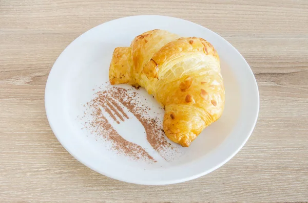 Croissant on a white plate — Stock Photo, Image