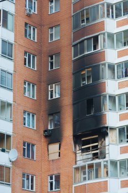 Front and windows of a condominium after an explosion and fire in its apartment. clipart