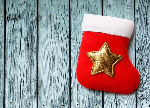 Red christmas stocking with golden star — Stock Photo, Image