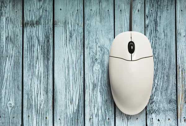 Computer mouse on wooden texture