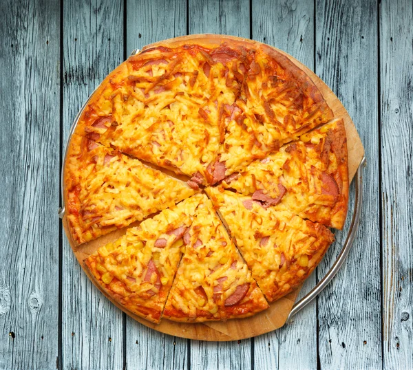 Sliced home pizza with cheese — Stock Photo, Image