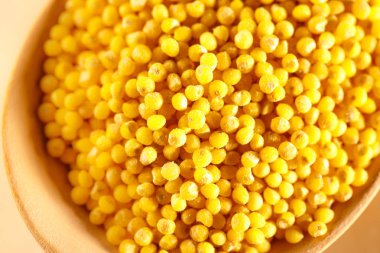 darı kabuğu çıkarılmış tane tahta kaşıkla