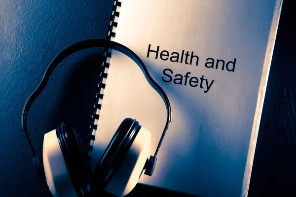 Gezondheid en veiligheid document met koptelefoon — Stockfoto