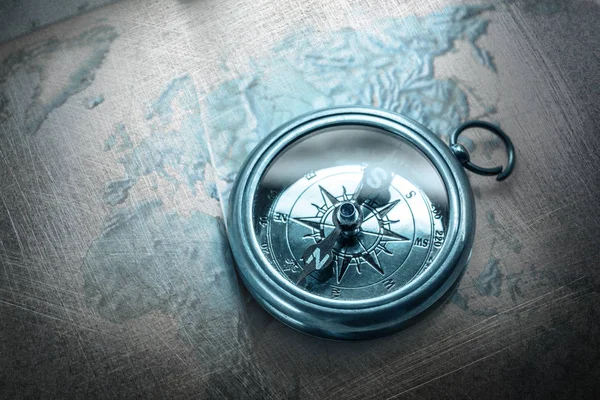 Old compass lying on map — Stock Photo, Image
