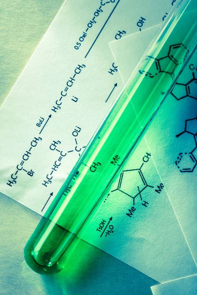 Chemical tube with reaction formula — Stock Photo, Image