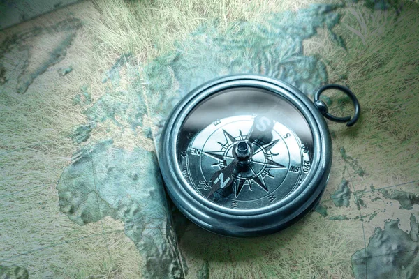 Old compass lying on map — Stock Photo, Image