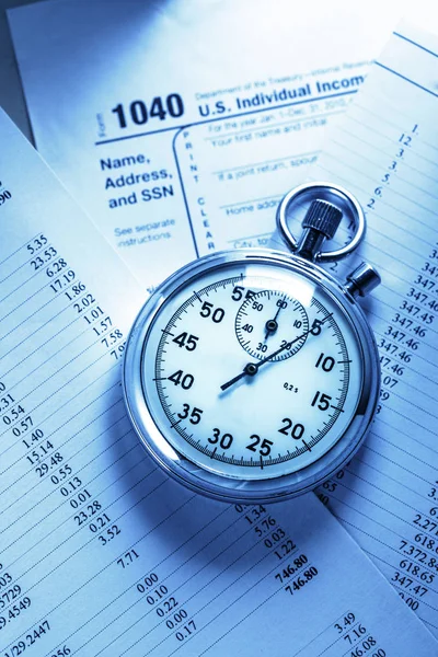 Stopwatch lying on tax form — Stock Photo, Image