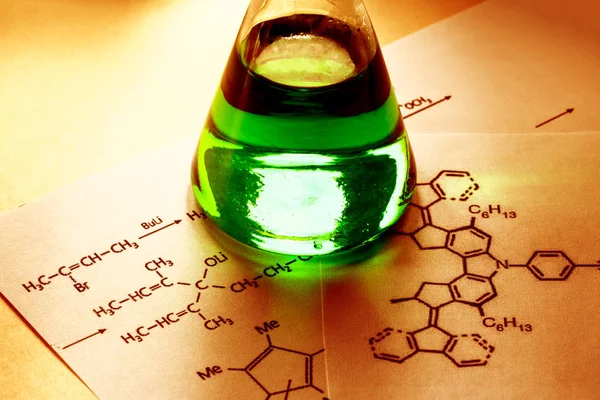 Chemical tube with reaction formula — Stock Photo, Image