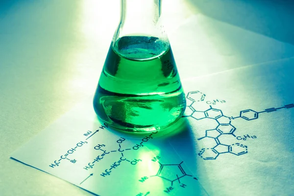 Chemical tube with reaction formula — Stock Photo, Image