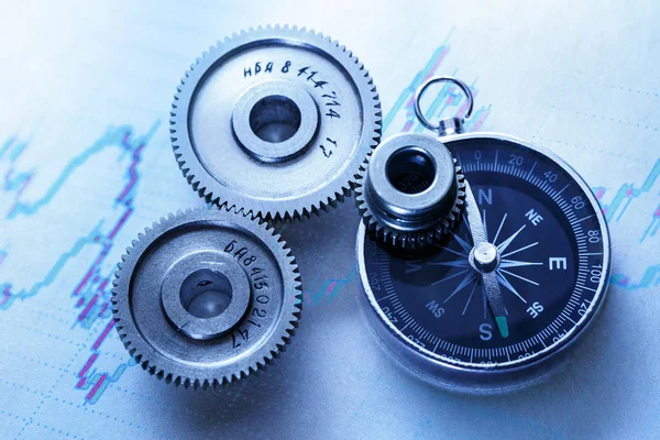 Steel cogwheels with compass — Stock Photo, Image