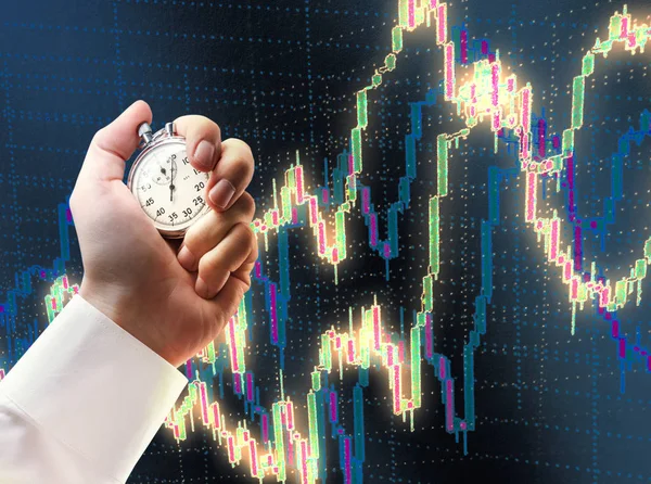 Candlestick chart and stopwatch in male hand — Stock Photo, Image