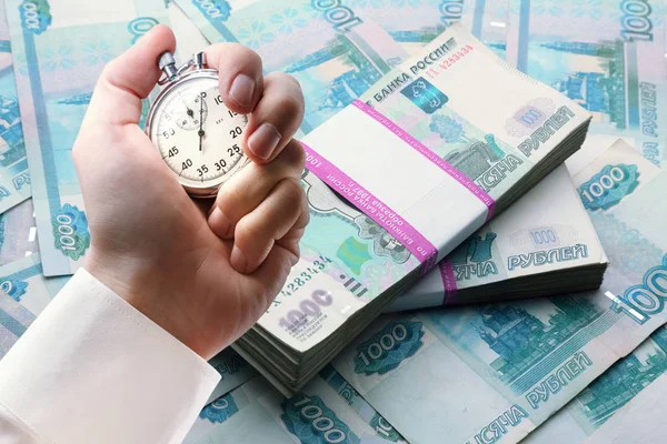Money and stopwatch in male hand — Stock Photo, Image