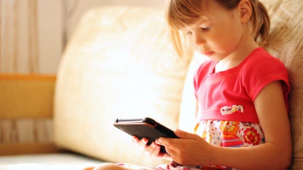 Gadis kecil memegang e-book di tangannya — Stok Video