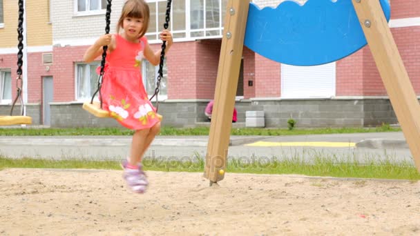 Little girl swinging on swing outdoor — Stock Video