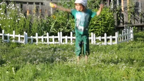 Child blowing soap bubbles in the garden — Stock Video