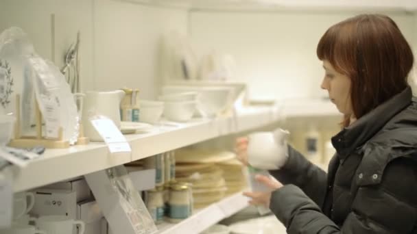 年轻女子在商店选购陶器 — 图库视频影像