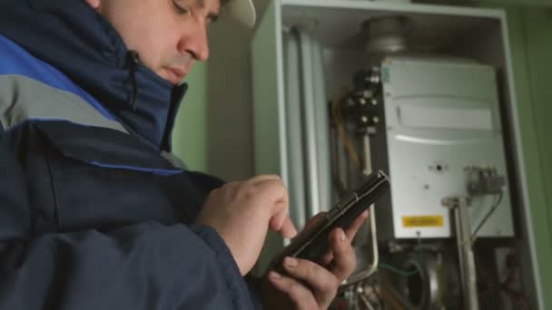 Worker Typing Smartphone Gas Fire Boiler — Stock Video