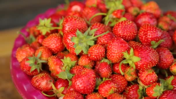 Strawberries in bowl in closeup — Stock Video