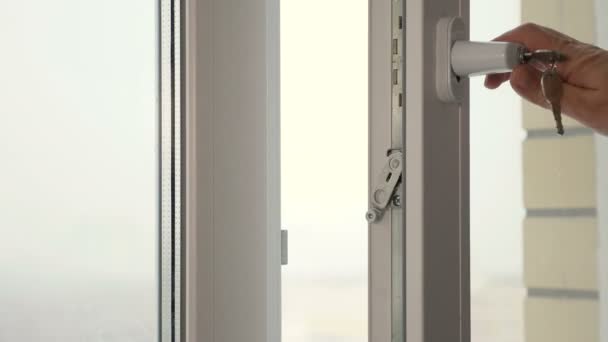 A man closing a window with a key — Stock Footage A man closing a window with a key Video Clip