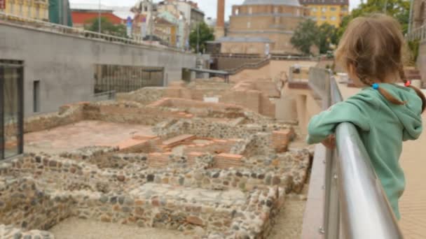 Маленькая девочка у руин Сердики в Софии — стоковое видео