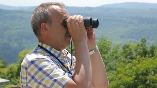 Dürbünle bakan erkek turist — Stok video