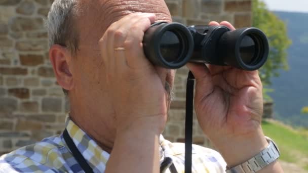 Turista masculino mirando a través de prismáticos — Vídeos de Stock