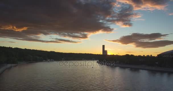 Cityscape with river traffic and movement of the clouds at sunset — Stock Video