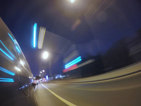 Auto se pohybuje vysokou rychlostí na silnici město noci. — Stock fotografie