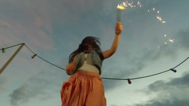 Woman jumping with firework candle — Stock Video