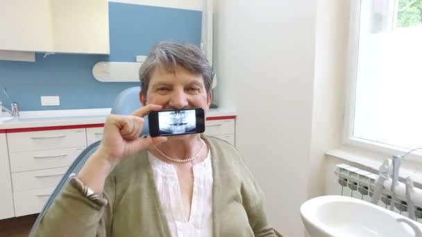 Woman holding smartphone with X- ray — Stock Video