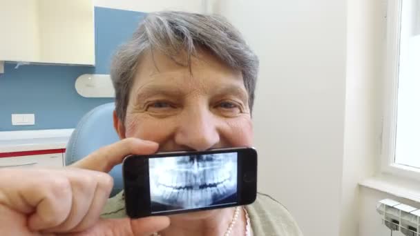 Woman holding smartphone with X- ray — Stock Video